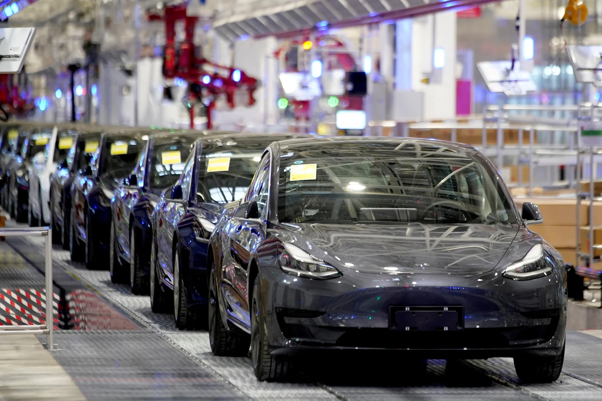 Tesla Sales in China: charging station with multiple vehicles plugged in.