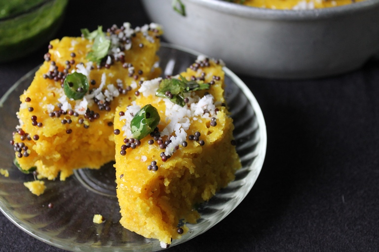 Soft and spongy Dhokla slices on a white plate 